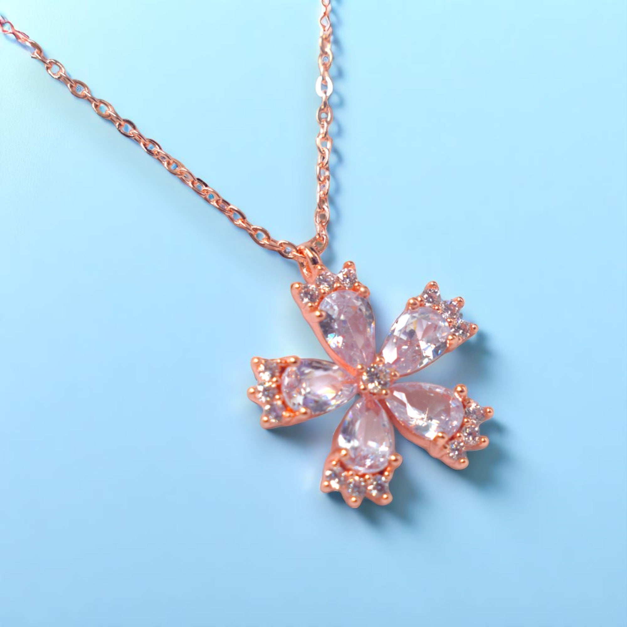 a gold diamond necklace on a light blue background
