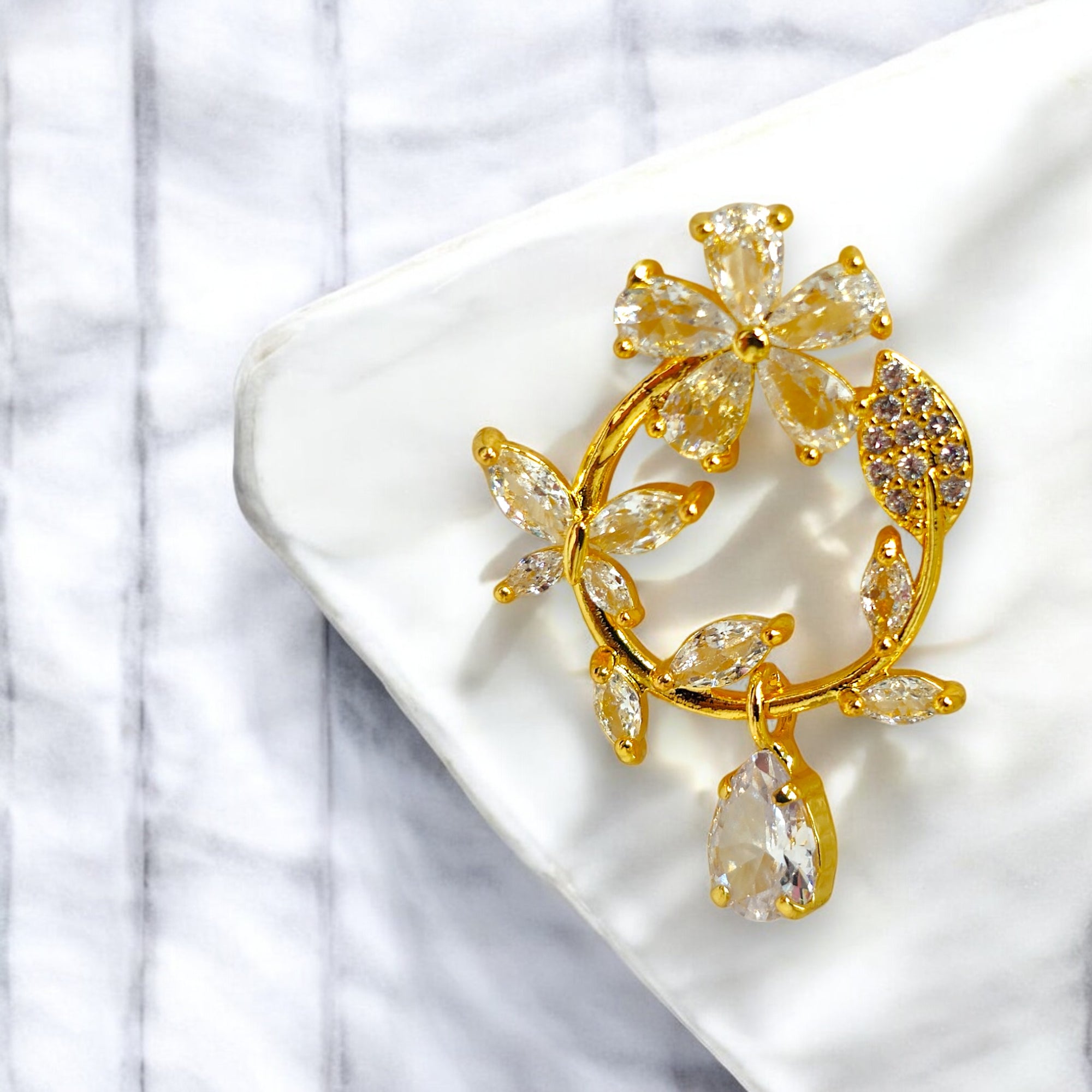 Gold floral hoop earrings with Zirconia crystal petals and teardrop gemstone, inspired by cherry blossoms 