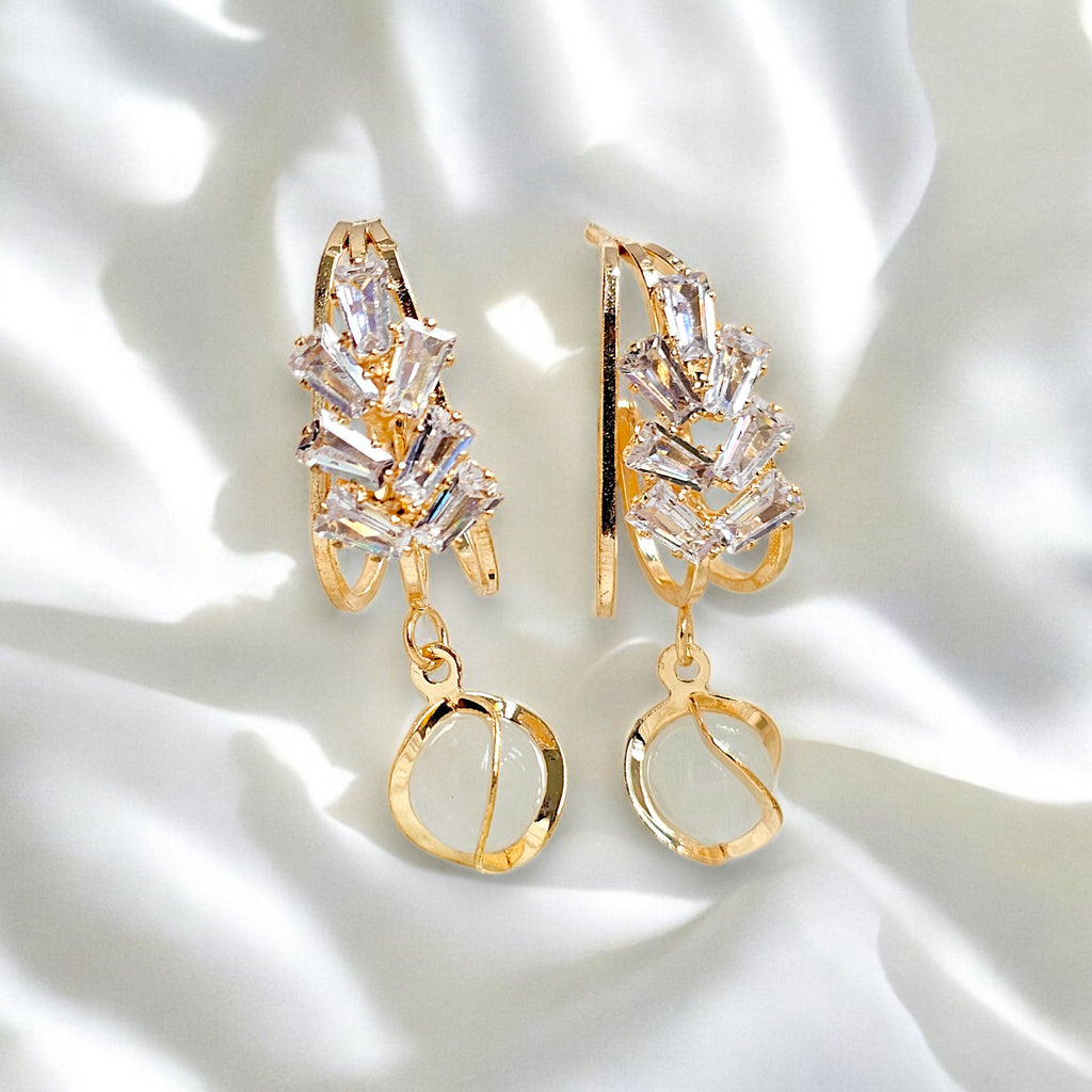 Elegant gold-plated dangle earrings featuring sparkling Zirconia crystals encased in a gold frame