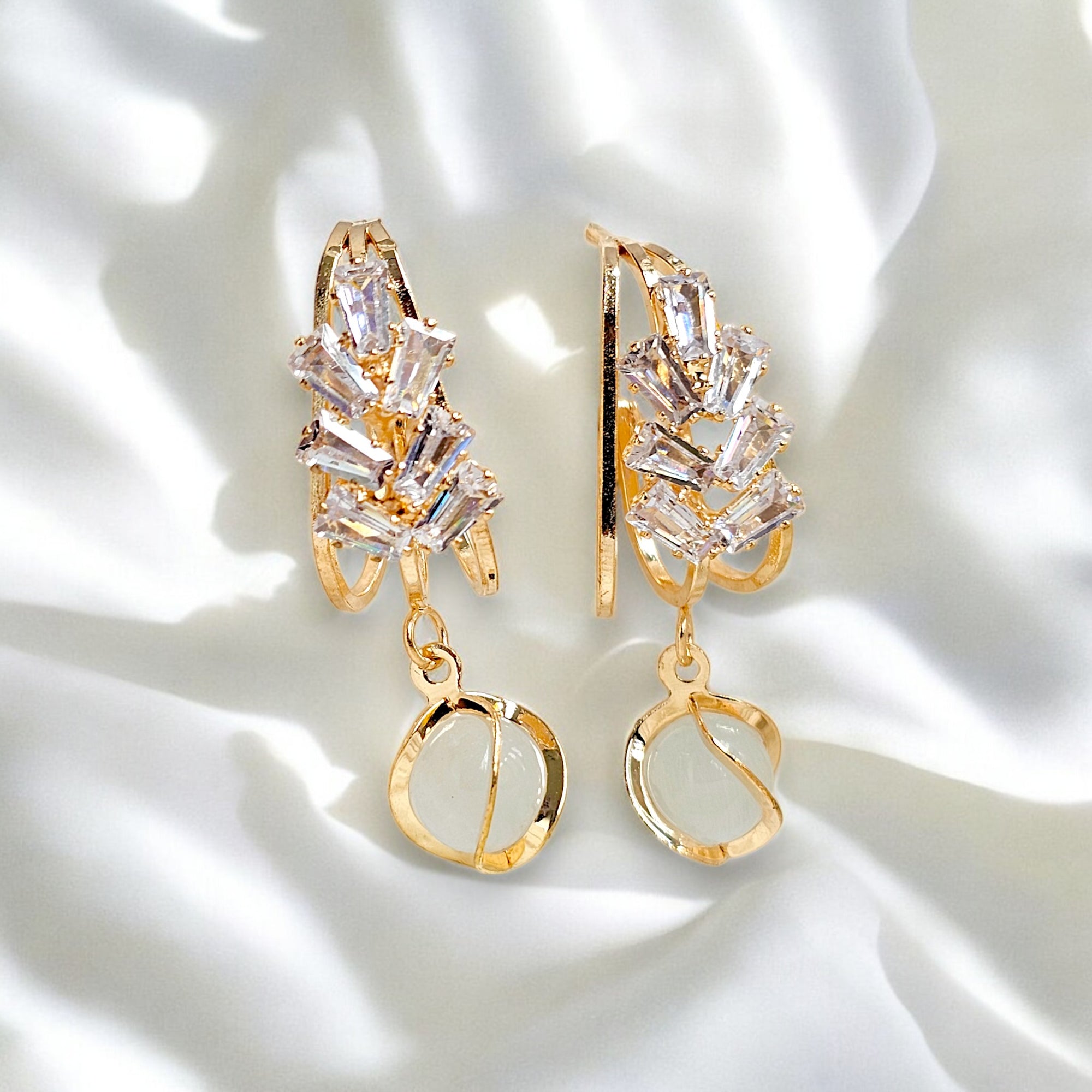 Elegant gold-plated dangle earrings featuring sparkling Zirconia crystals encased in a gold frame