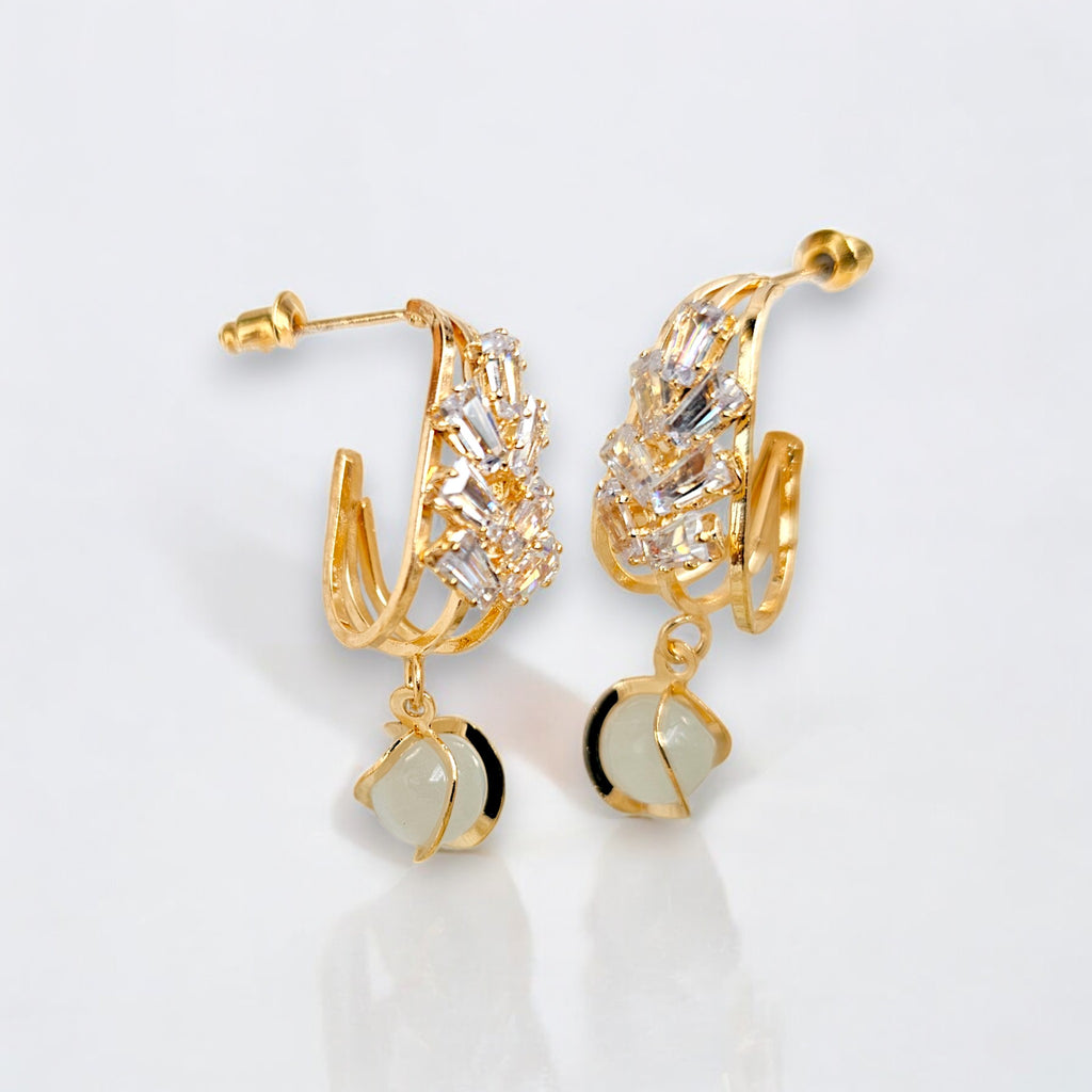 Elegant gold-plated dangle earrings featuring sparkling Zirconia crystals encased in a gold frame white background