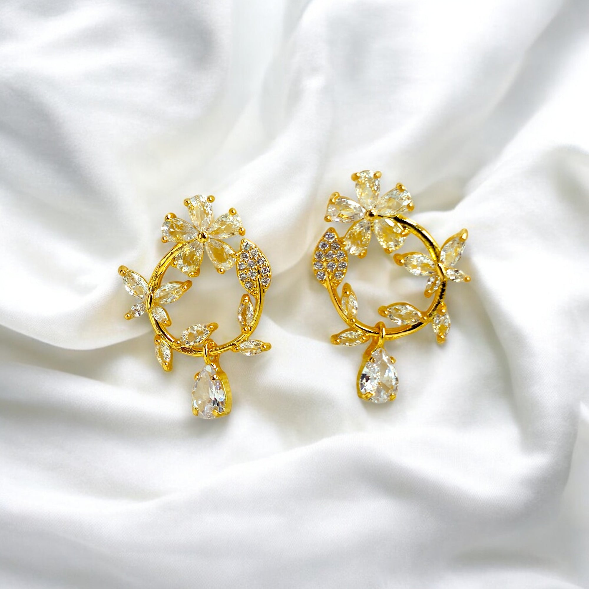 Gold floral hoop earrings with sparkling crystal petals and teardrop gemstone, inspired by cherry blossoms 