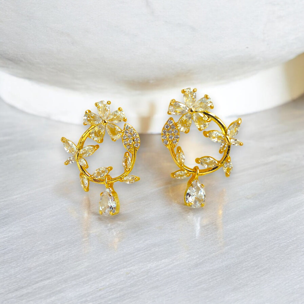Gold floral hoop earrings with Zirconia crystal petals and teardrop gemstone, inspired by cherry blossoms 