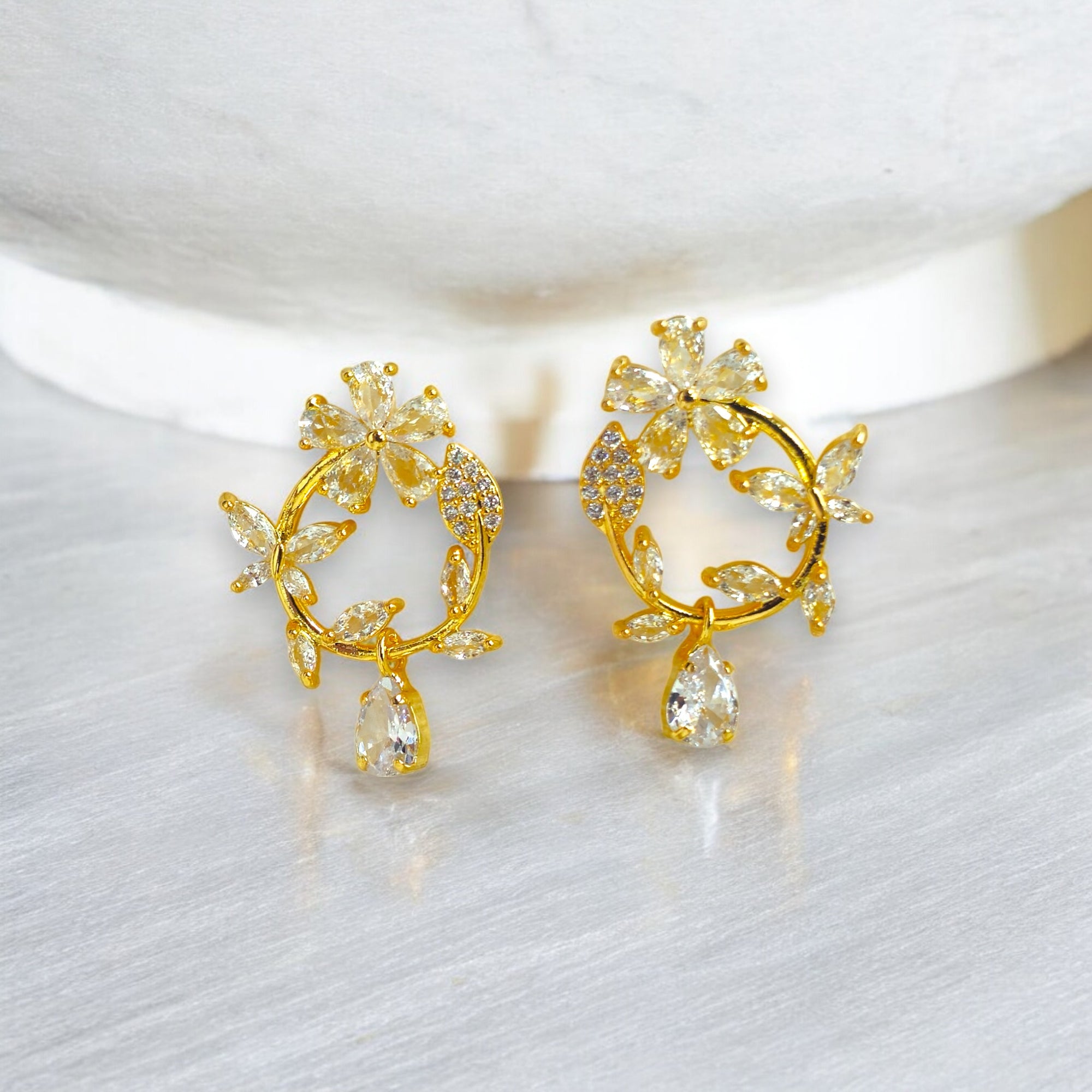 Gold floral hoop earrings with Zirconia crystal petals and teardrop gemstone, inspired by cherry blossoms 