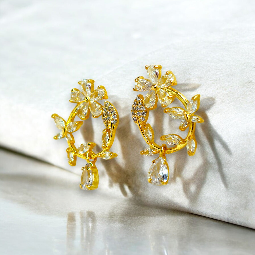 Gold floral hoop earrings with Zirconia crystal petals and teardrop gemstone, inspired by cherry blossoms 