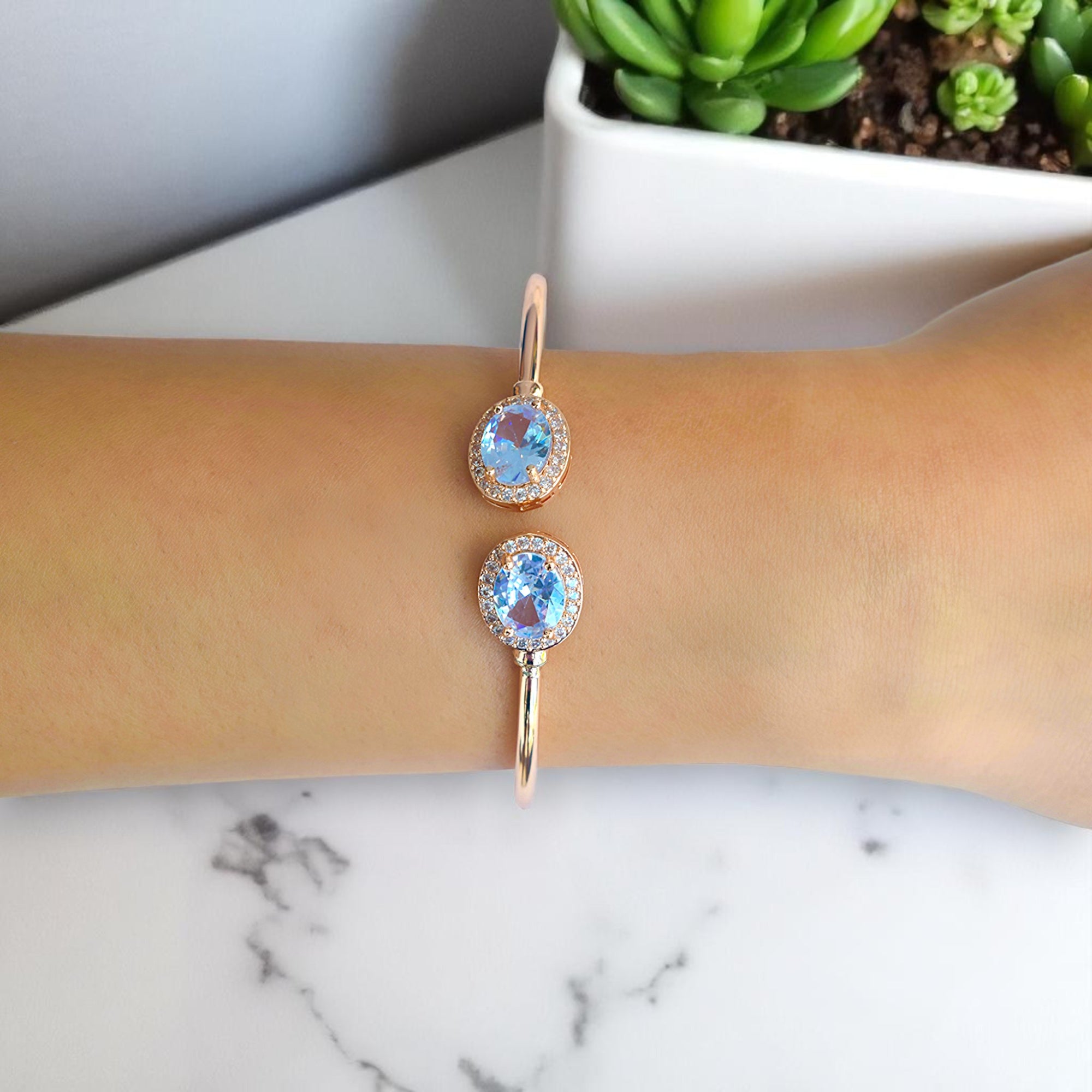 a girl wearing a rose gold diamond studded bangle on her right hand