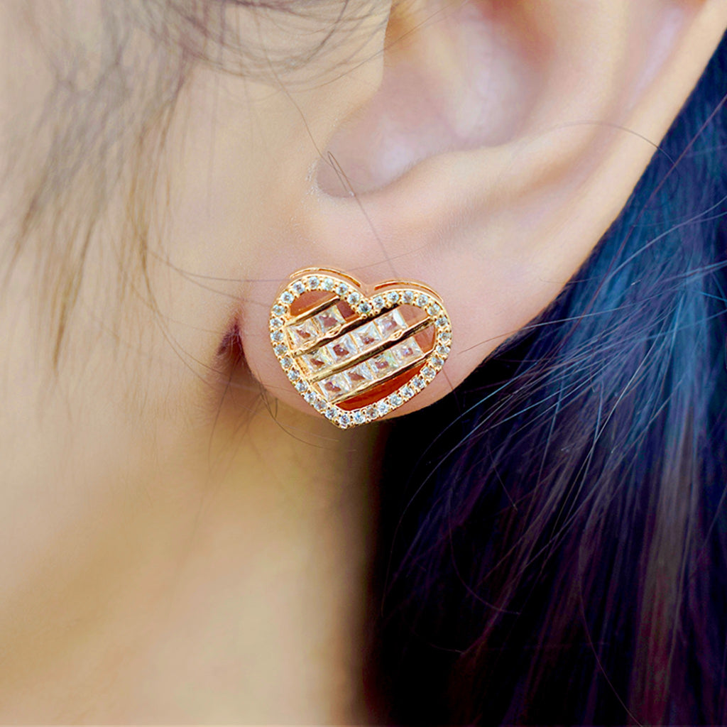 a girl wearing a heart shaped zirconia stoned gold earring