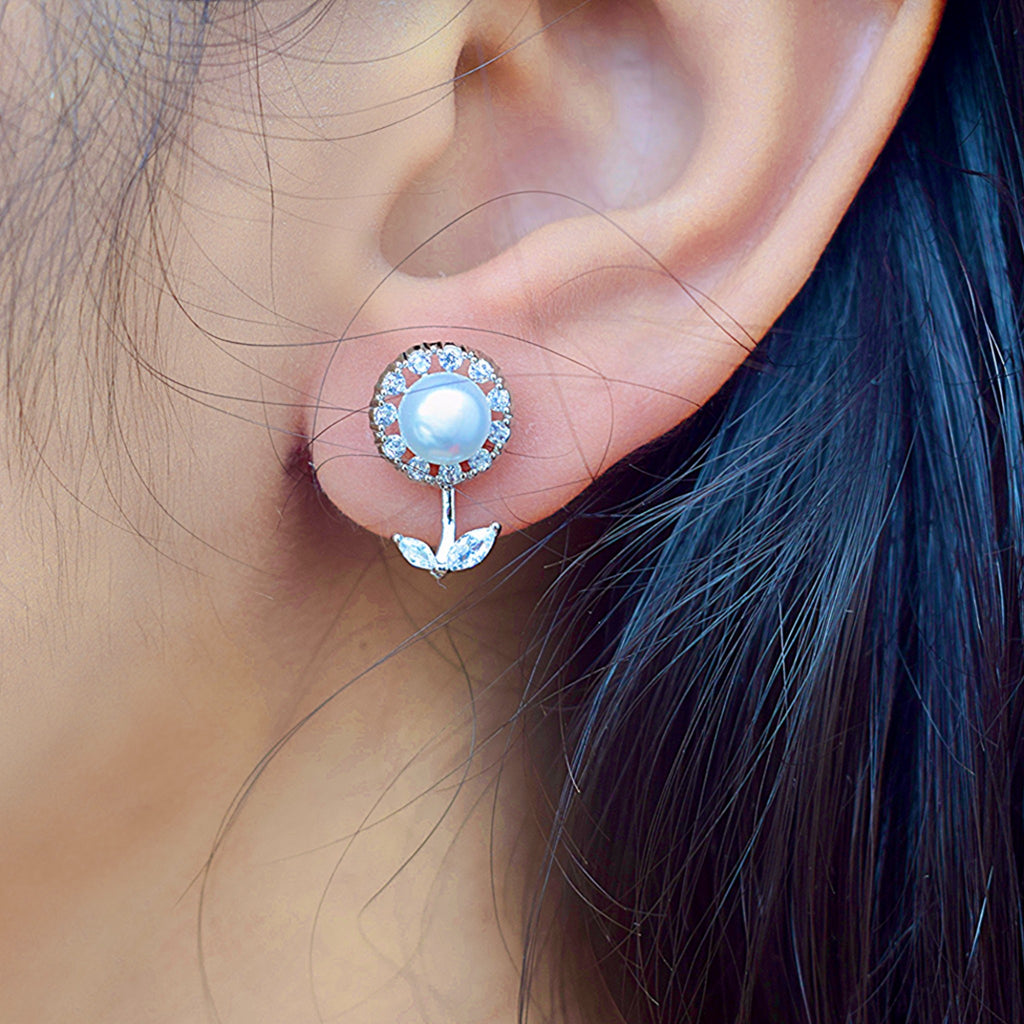A girl wearing a silver zirconia stone pearl earring