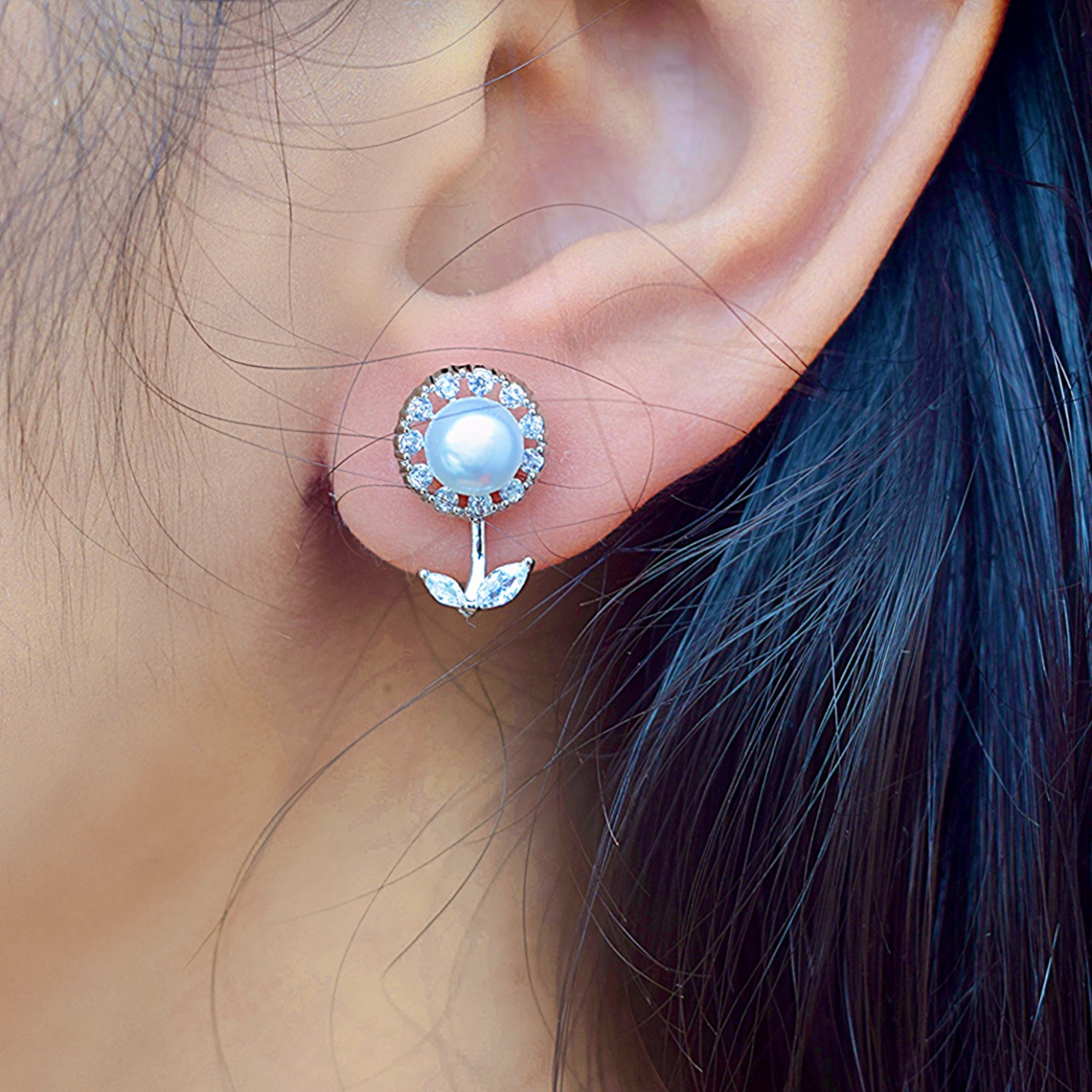 A girl wearing a silver zirconia stone pearl earring