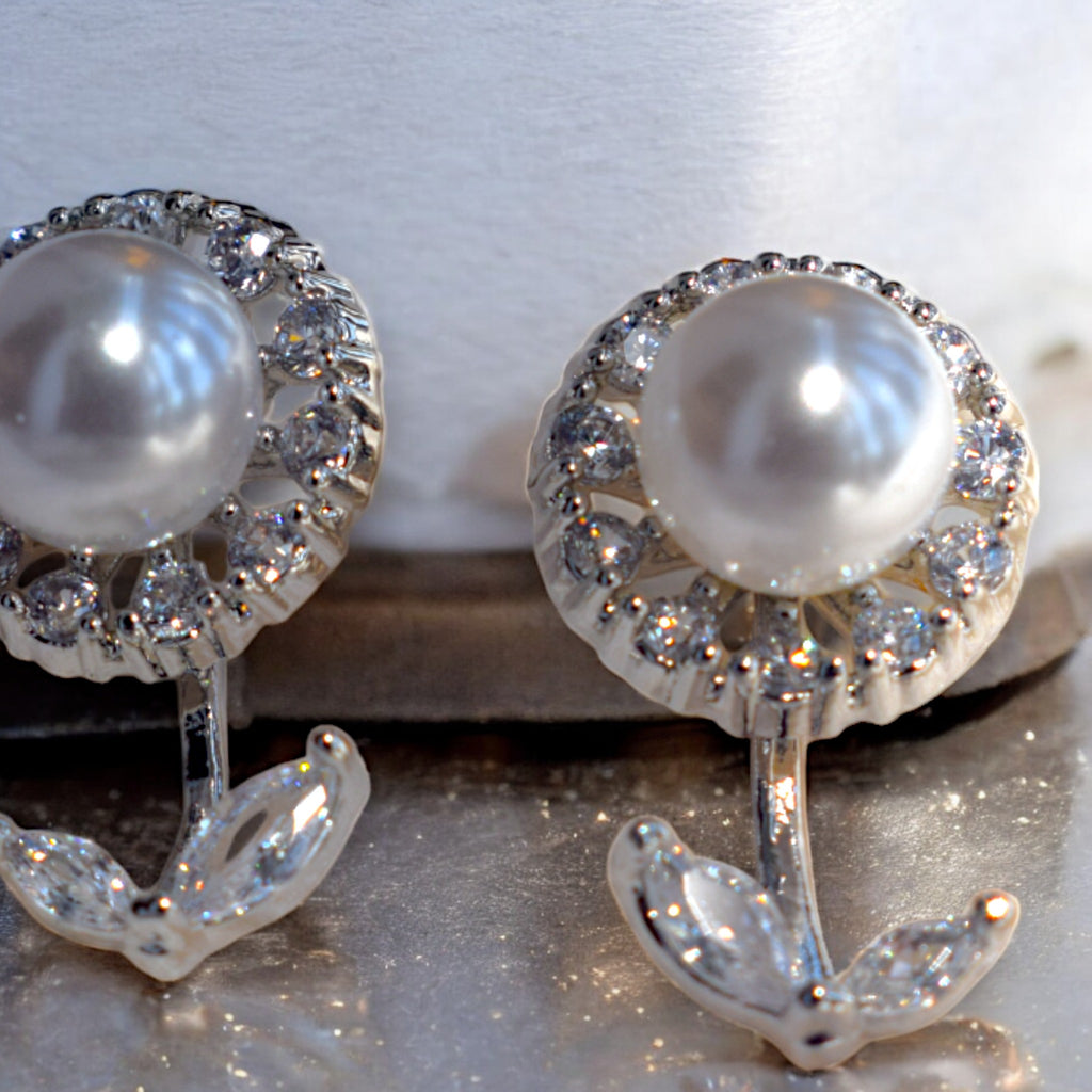 Close up of Kansobi Silver Pearl Zirconia Stone earrings kept on a white base