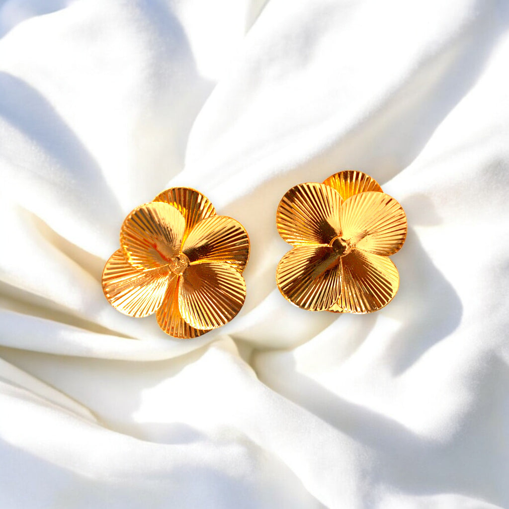 14k Gold flower petal earrings on a white satin cloth