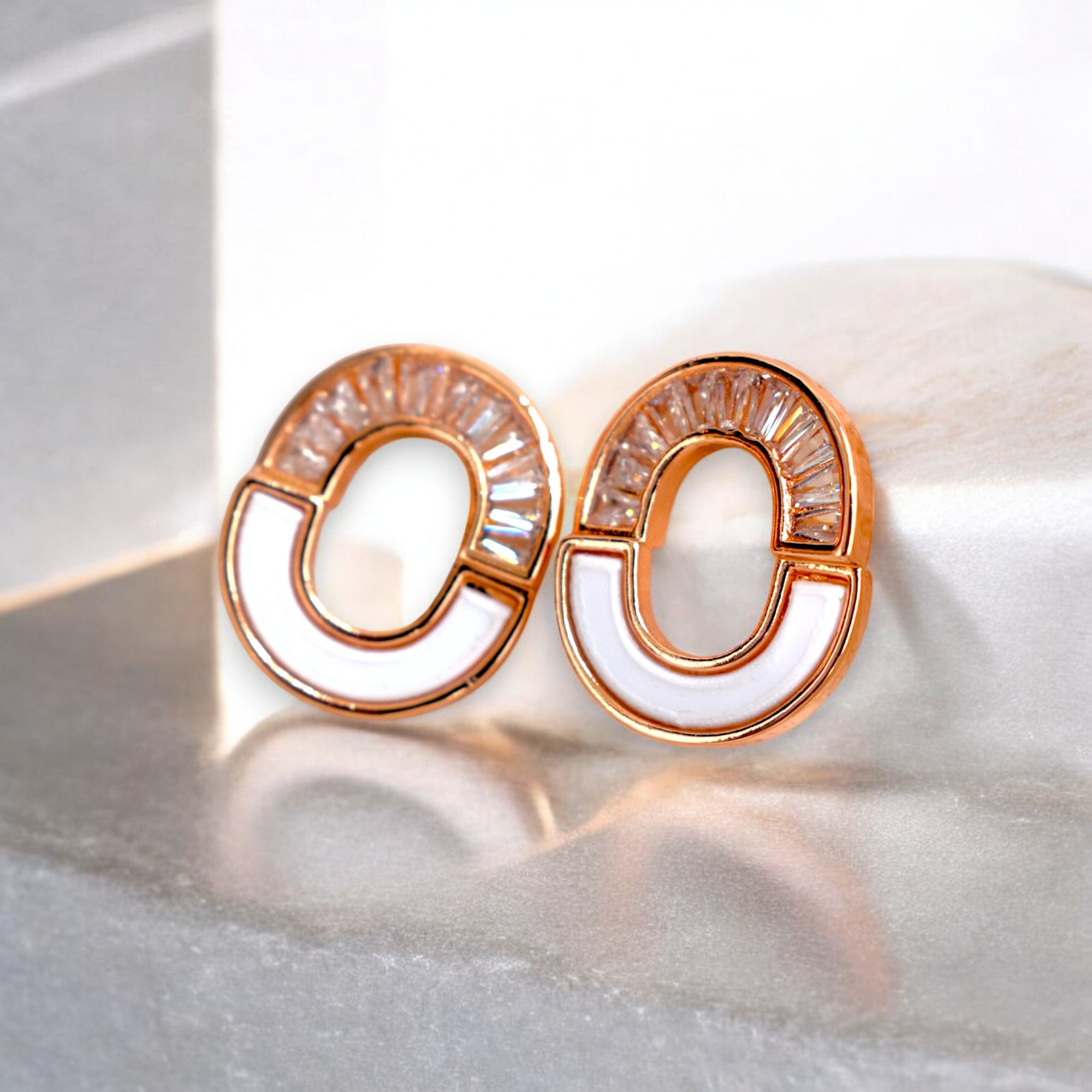 kansobi Rose gold round zirconia stone earrings on a white marble floor
