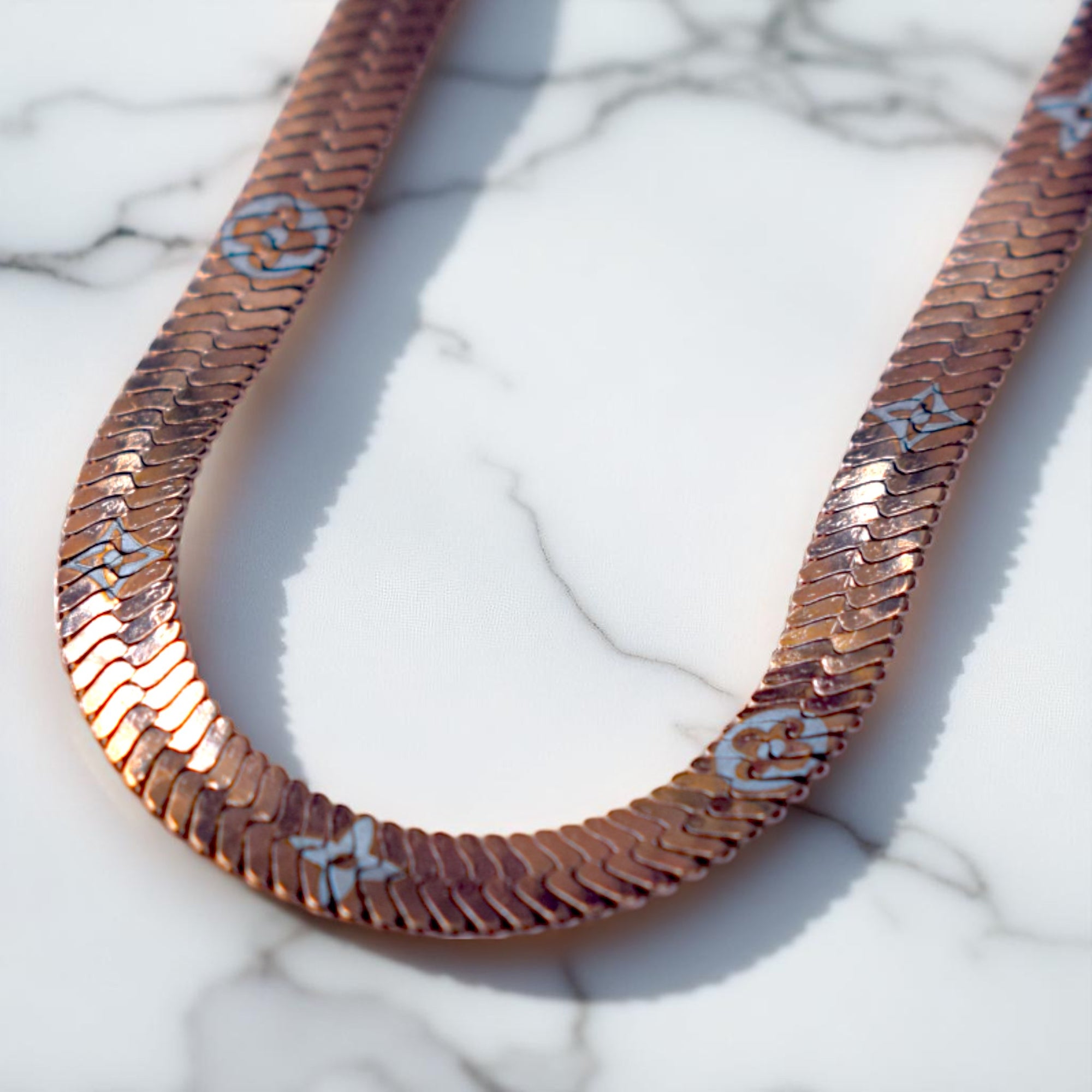 Decorative necklace with butterfly patterns on a marble surface