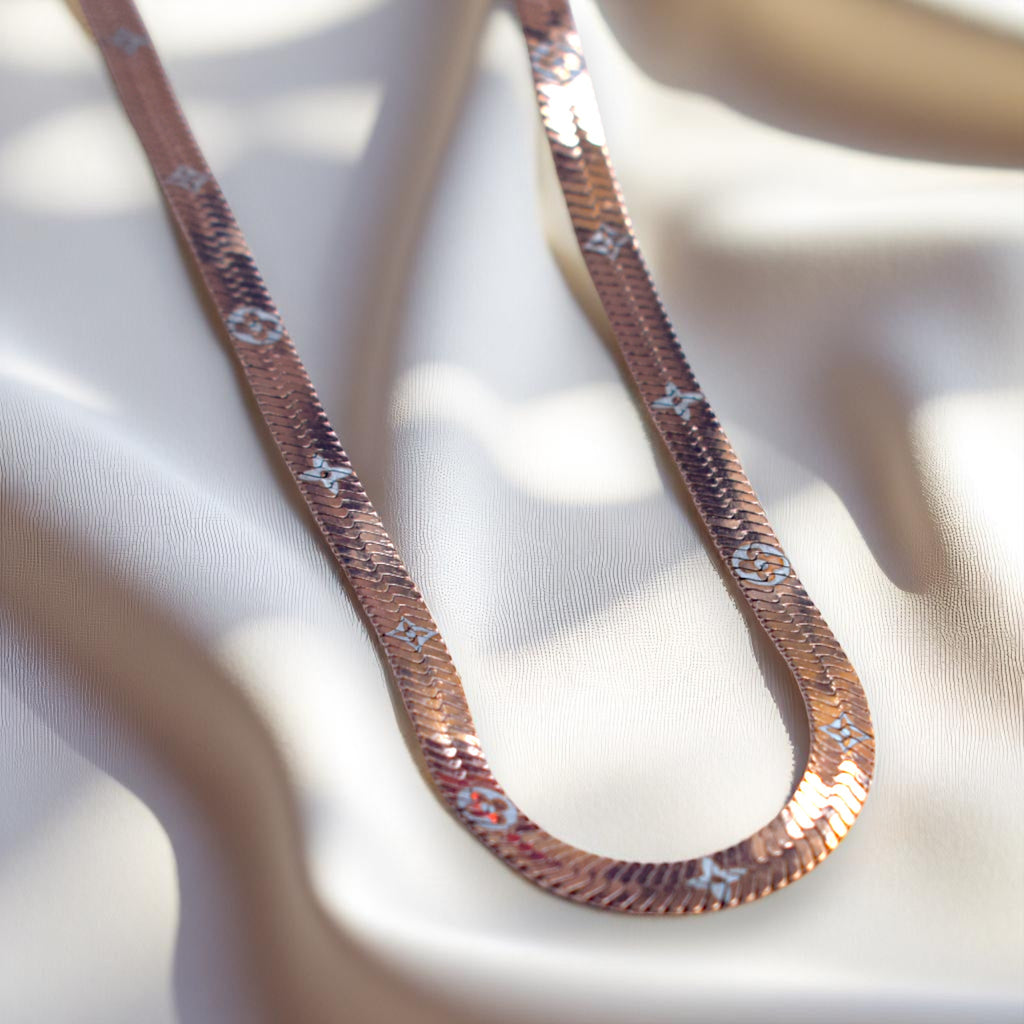 Necklace with a textured chain on a light fabric background