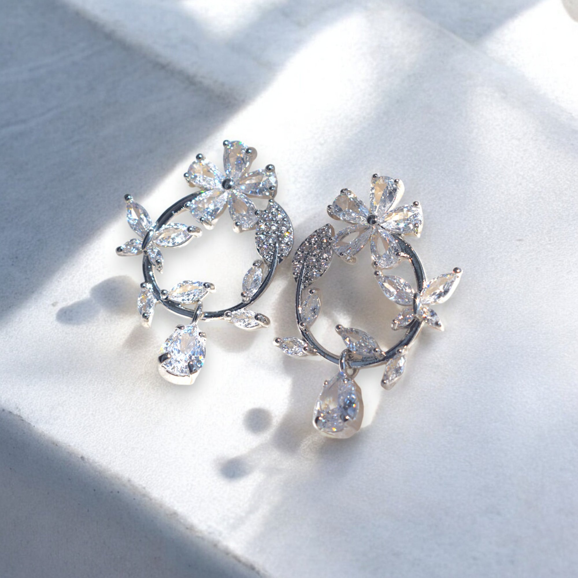 Silver floral hoop earrings with Zirconia crystal petals and teardrop gemstone, inspired by cherry blossoms 