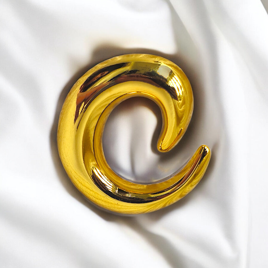 Gold crescent hoop earrings with a bold, high-polish finish, perfect for statement jewelry lovers