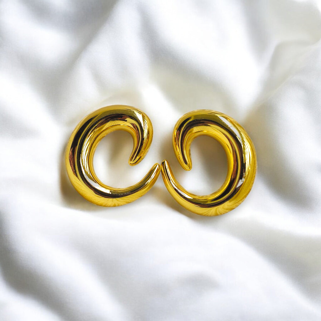 Gold crescent hoop earrings with a bold, high-polish finish, perfect for statement jewelry lovers