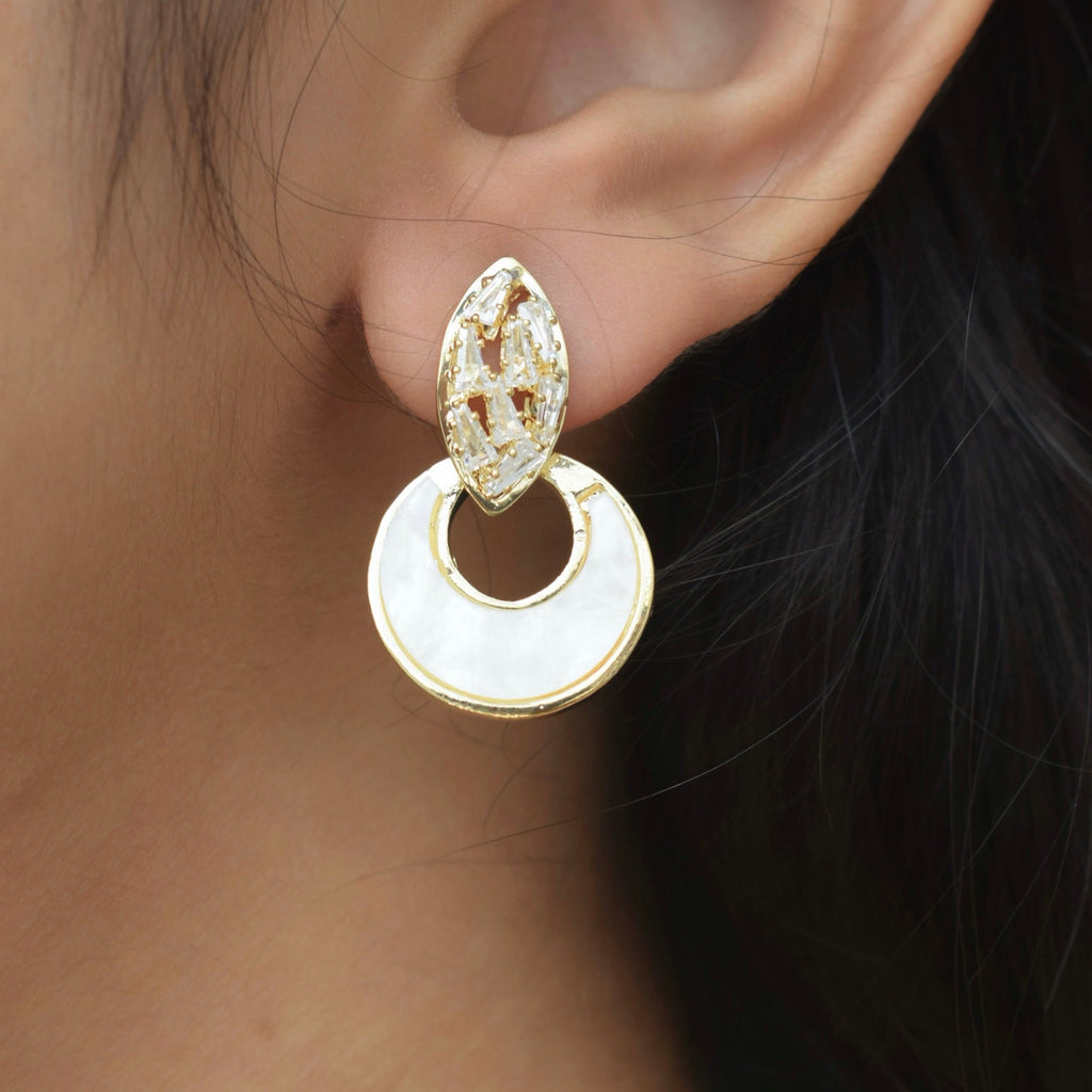 side view of a girl wearing a golden crescent moon zirconia stone studded earring