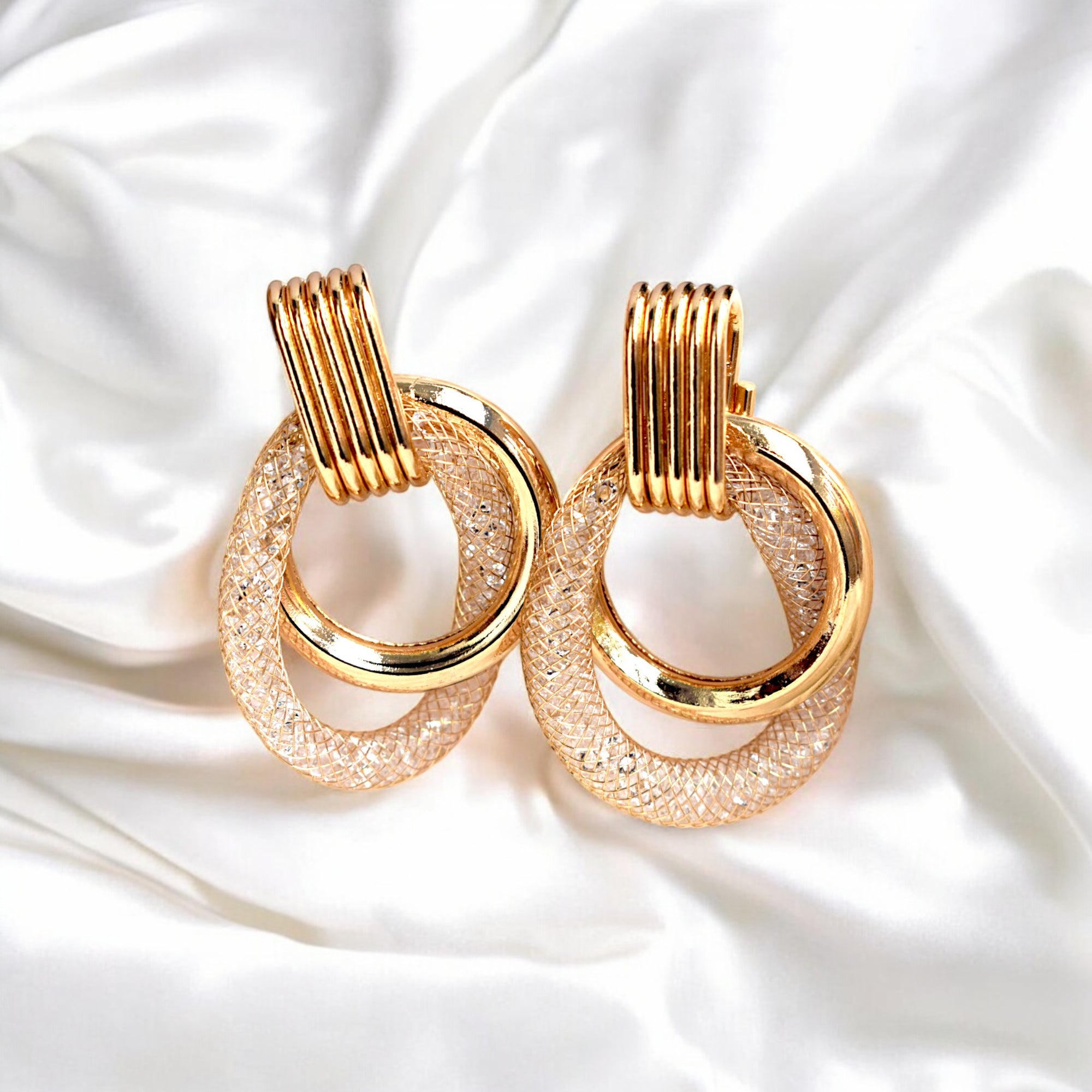 Gold color plated hoop earrings with sparkling zirconia diamonds in a sleek, modern design