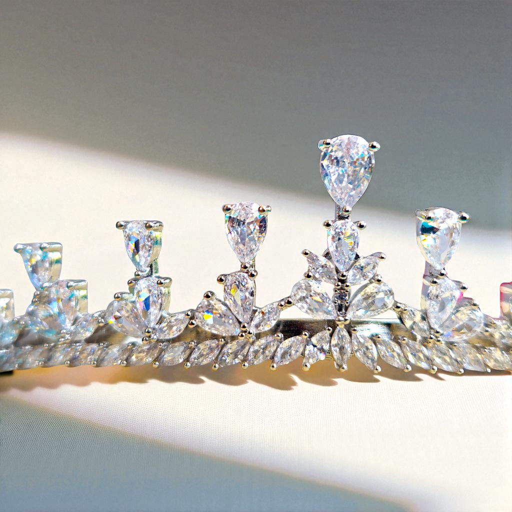 Diamanté tiara on a reflective surface with a neutral background