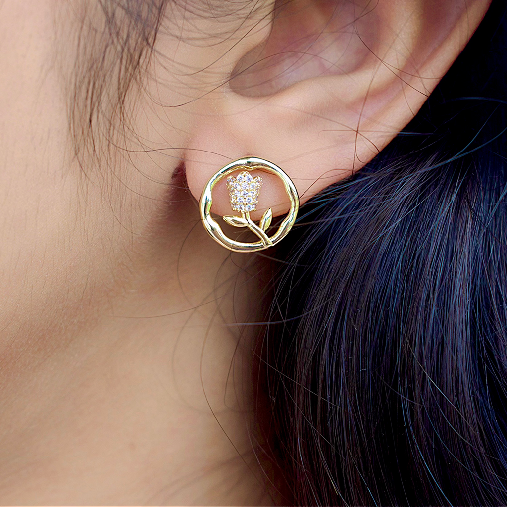 side view of a girl wearing a gold round flower earrings with Zirconia stones