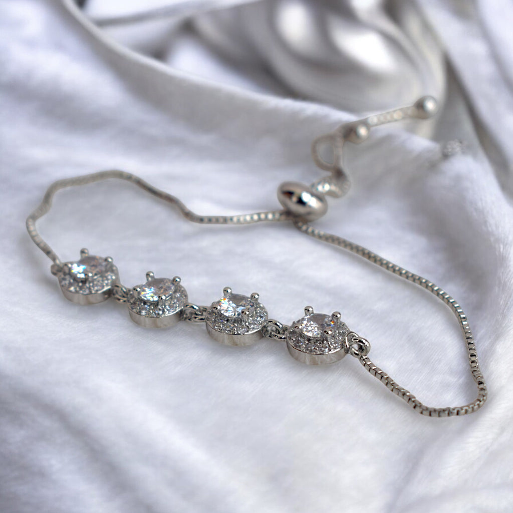 Diamond stoned silver circle chain bracelet on a white satin cloth
