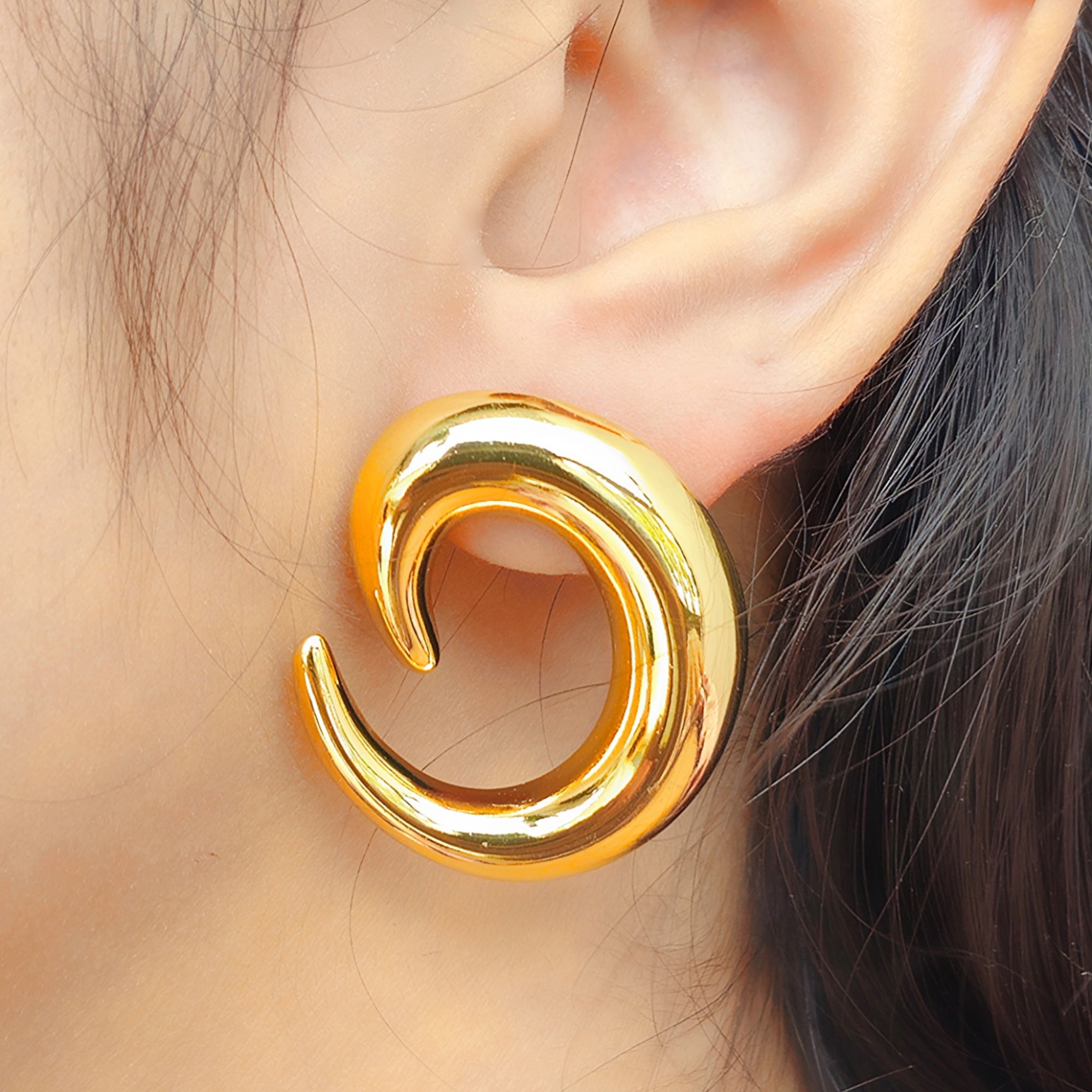 side view of kansobi 14k golden hoop earrings worn by a girl 