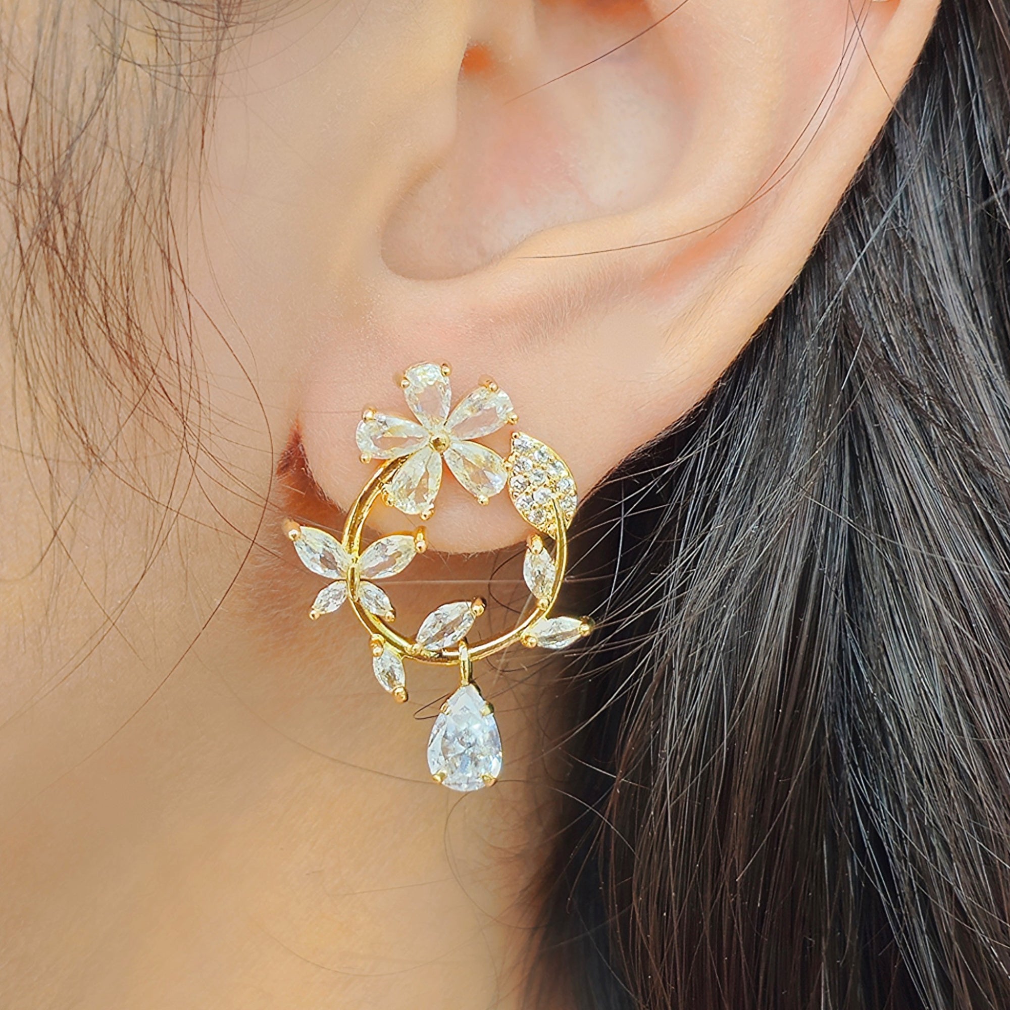 side view of kansobi gold zirconia stone flower bloom earrings 