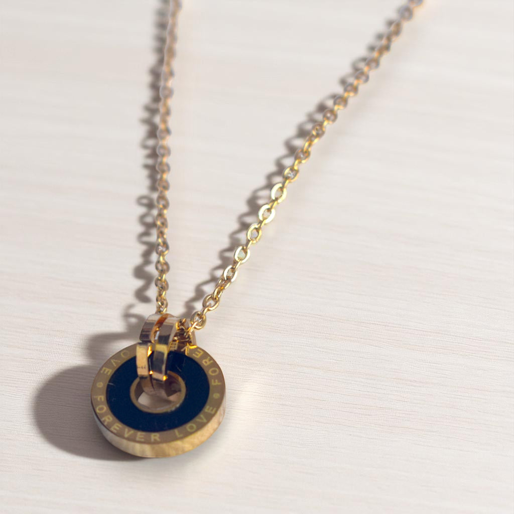 Necklace with gold chain and blue pendant on a white background