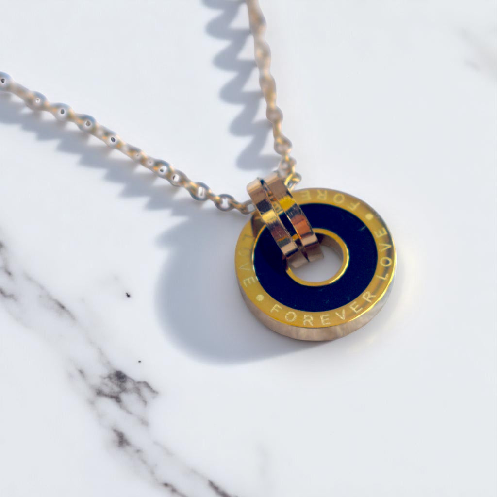 Necklace with a blue and gold pendant on a marble surface