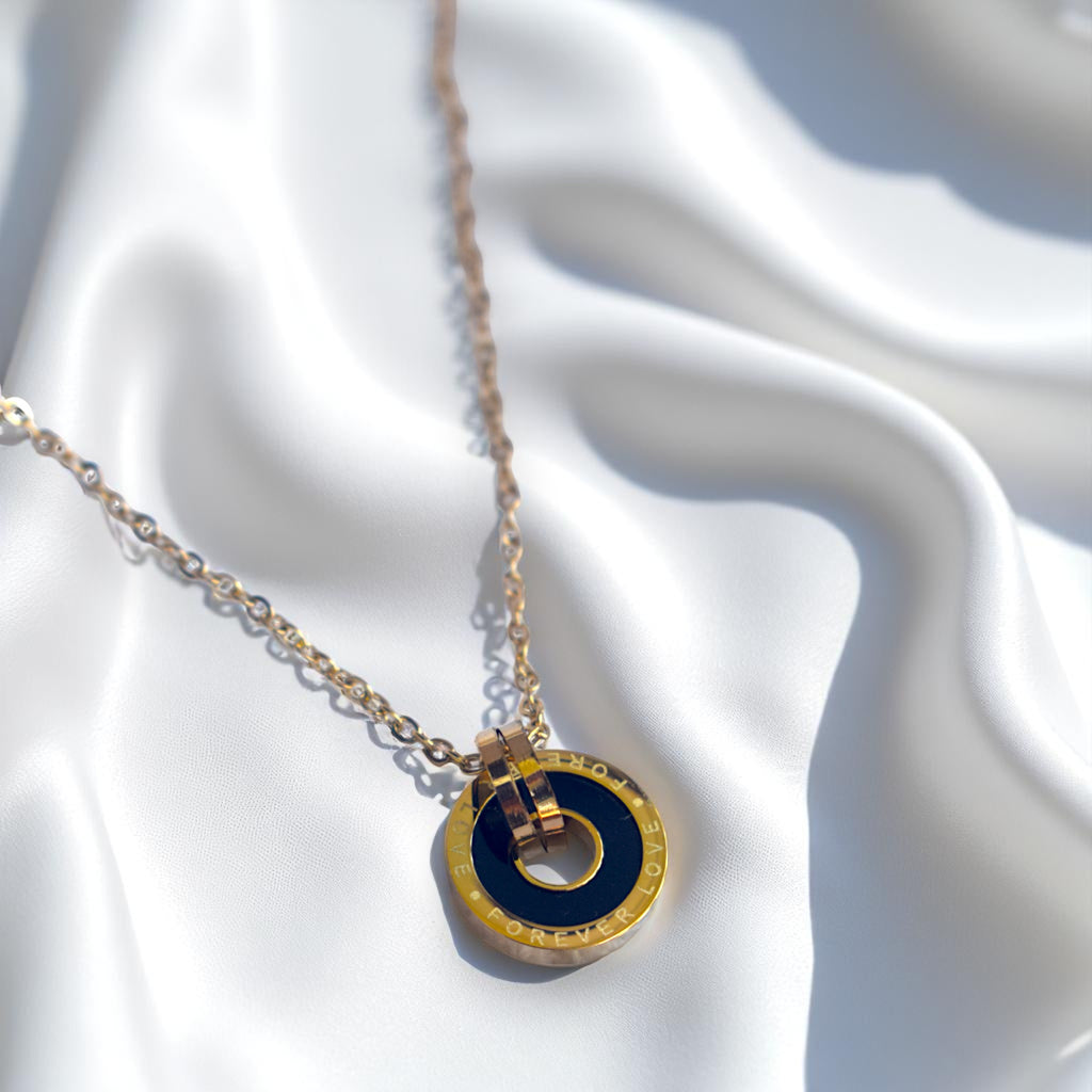 Necklace with a blue and gold pendant on a white fabric background