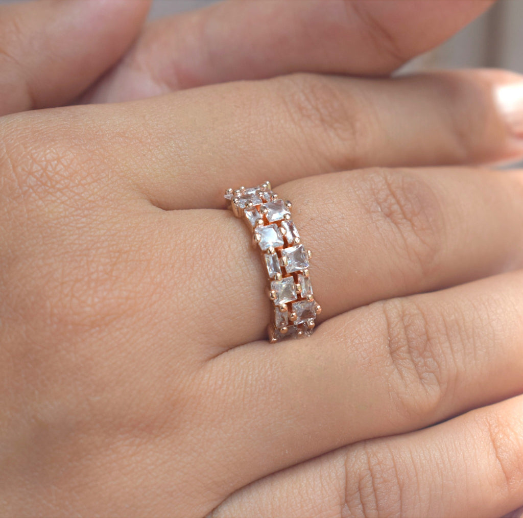 Rose gold ring with zirconia diamonds on a hand