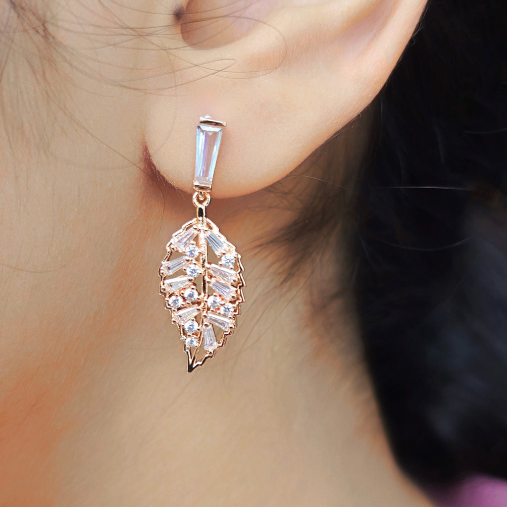 rose gold zirconia stone leaf earring worn by a girl