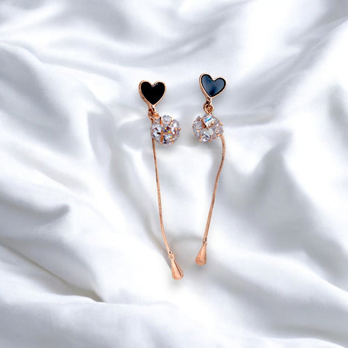 Rose gold heart earrings with Round zirconia diamonds on a white satin cloth