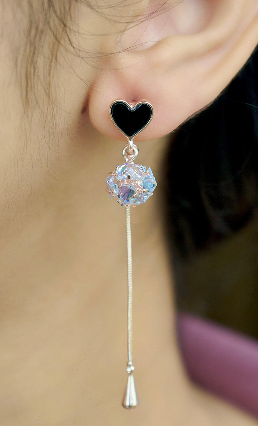 side view of a rose gold heart drop earring with zirconia round diamond worn by a girl