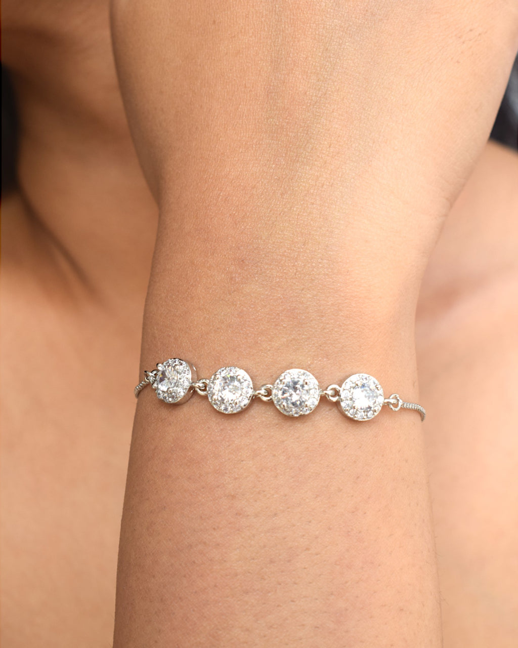 close of a girl wearing a silver diamond studded bracelet on her right hand