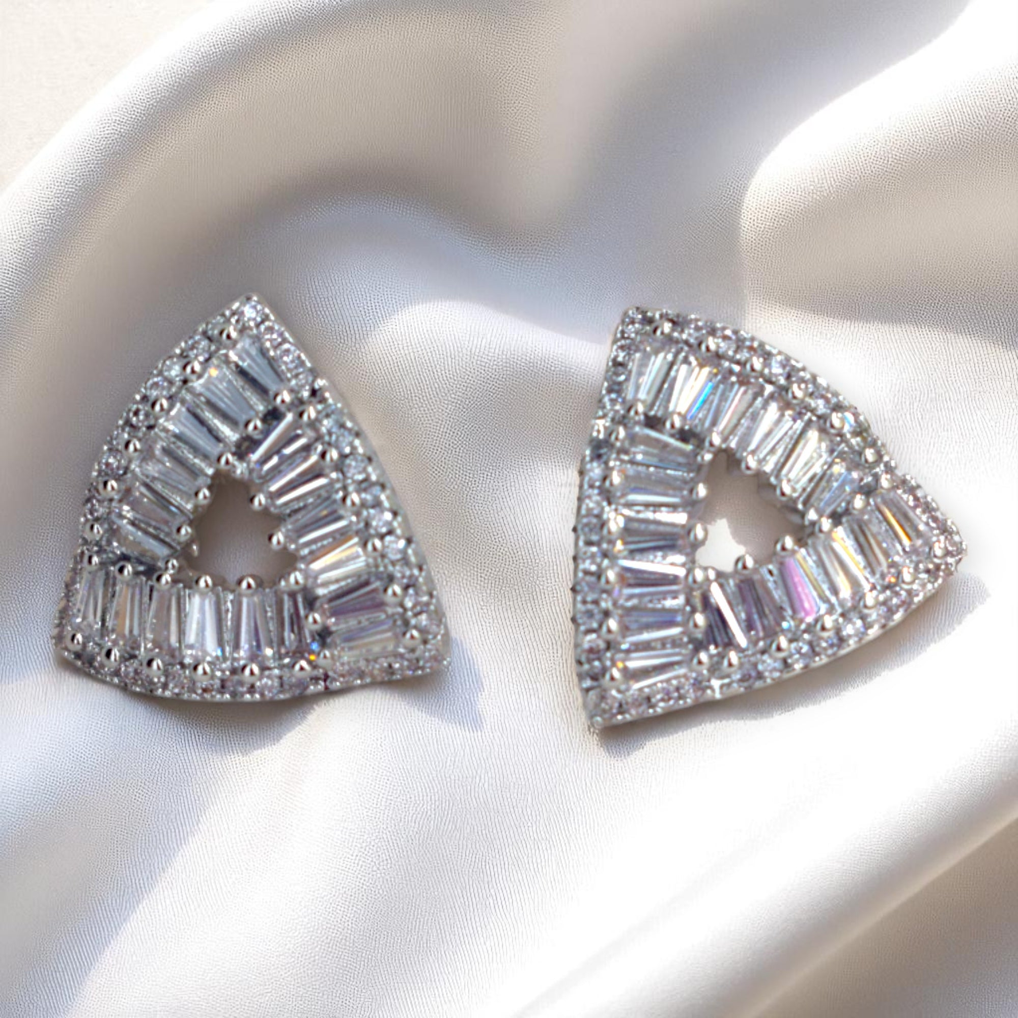 Triangular diamond earrings on a white background