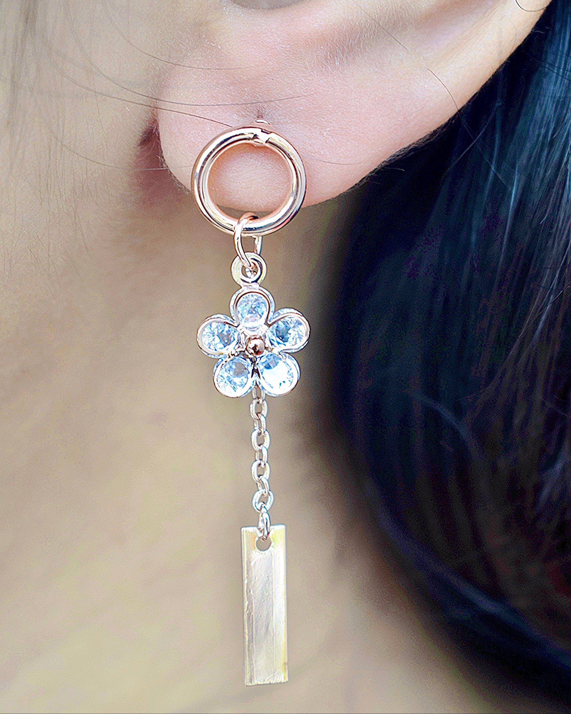 side view of a women wearing a rose gold flower drip zirconia stone earring