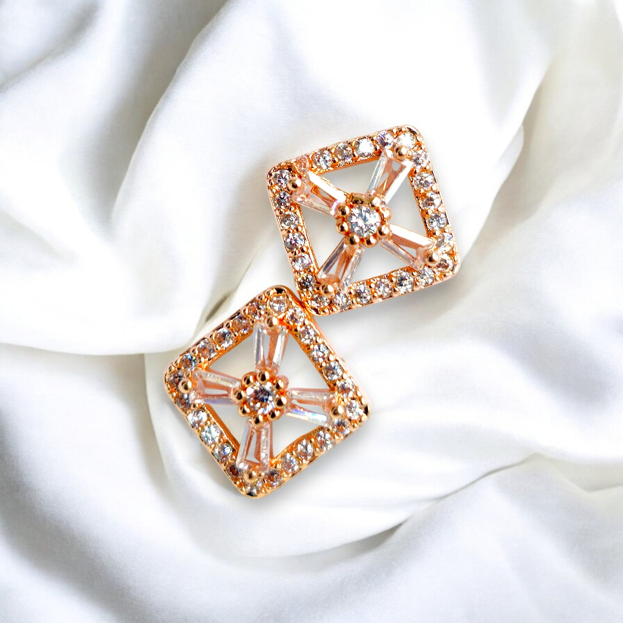 Rose gold earring set with Zirconia crystal studs white background Korean jewelry